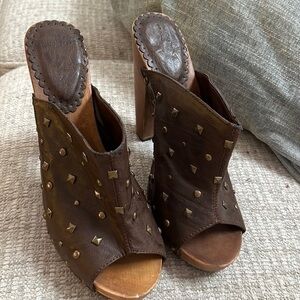 Brown studded women’s shoe size 7 on wooden base